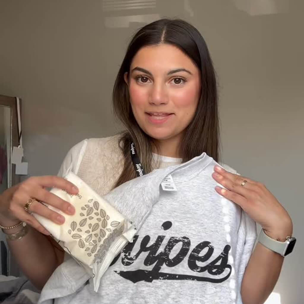 Social media post of a woman holding up a pack of Twipes flushable wet wipes